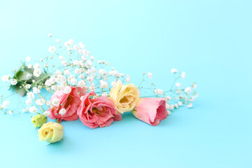 spring bouquet of pink and white flowers over pastel blue background
