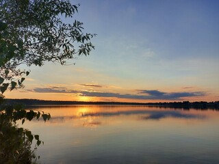 Fototapeta na wymiar Orange sunset over a large lake in the Moscow region. High quality photo