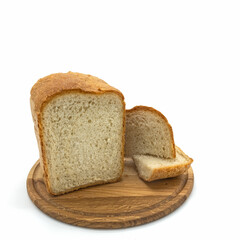 A loaf of freshly baked wheat bread with a golden crust and porous crumb on a round wooden board. There are two cut slices next to it. Isolated over white background.