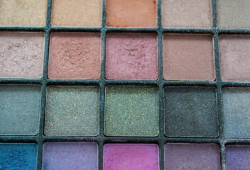 Close up palette with multi colored eye shadow. Makeup nude color, blue, turquoise and pink
