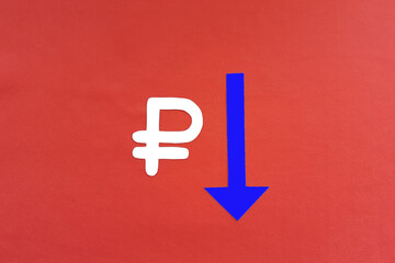 Ruble sign, a blue arrow pointing down on a red background. Depreciation of the ruble. Money.
