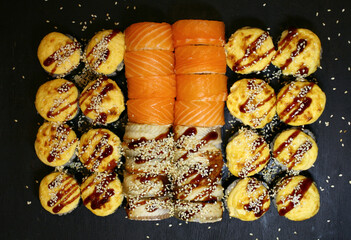 Tasty sushi set on black background