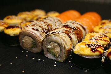Tasty sushi set on black background