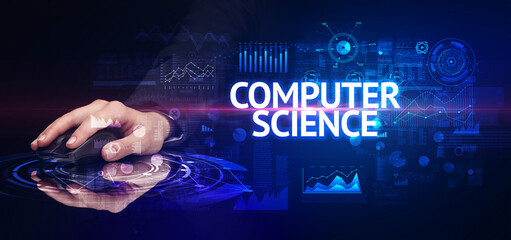 hand holding wireless peripheral with COMPUTER SCIENCE inscription, modern technology concept