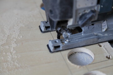 Electric jigsaw with a figured saw bit, sawing of large diameter holes in the plywood