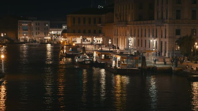 City of Venice at night with boat on the water and city lights