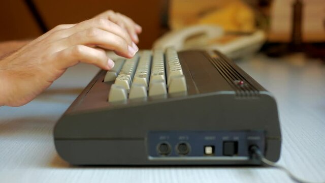 Man hand typing on old computer
