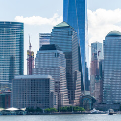 Detail of manhattan ferry pier and buildings from hudson river during summer with blue sky and cloud. New-York.