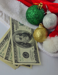 Dollars, decorations for the Christmas tree, santa claus hat and Christmas balls of different...