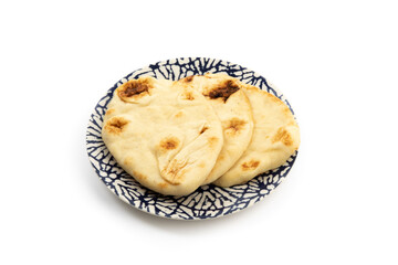 Naan bread on a blue plate isolated on a white background