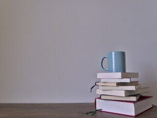 Stack of books on a table with light colored background.Education learning and reading concept