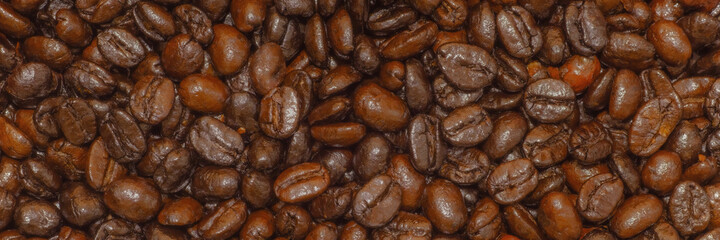 Roasted coffee beans on dark background, background from the fried coffee grains.