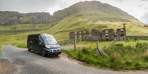 Black campingcar parked at ruin at Gleniff Horseshoe Drive