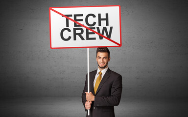 business person holding a traffic sign with TECH CREW inscription, new idea concept