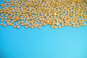 confetti in the form of yellow stars on top on a blue background