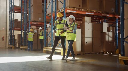 Retail Warehouse full of Shelves with Goods: Electric Forklift Truck Operator Drives by with Pallet with Cardboard Boxes. Specialists Count Stock in Logistics Delivery and Distribution Storehouse - Powered by Adobe