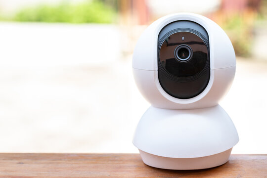 A blank white CCTV camera security that hasn't been installed on the table.