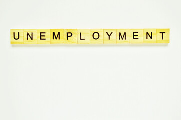 Word unemployment. Wooden blocks with lettering on top of white background. Top view of wooden blocks with letters on white surface