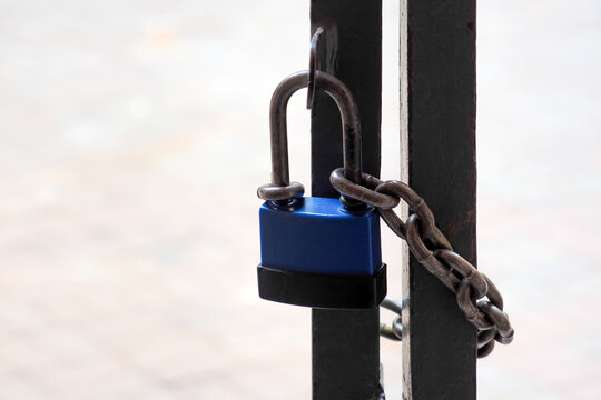 Locked Gate Tethered By Metal Chain And Padlock. Boarder, Closed Borders Immigration Concept. Lock With Chain