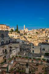 Fototapeta na wymiar Matera, Basilicata, Italy - Panoramic view of the Sassi of Matera, Caveoso. The ancient houses of stone and brick, carved into the rock. The cathedral in the background.