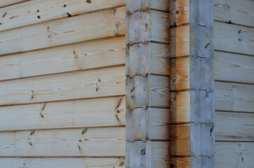 Fragment of a wooden house made of deciduous timber