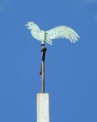 A mast with a metal rooster