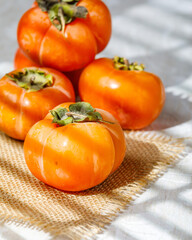 still life with persimmons. vertical image. selective focus