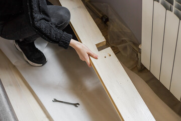 carpenter measuring wood plank