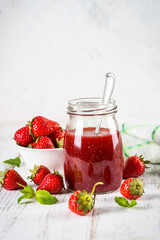 Strawberry jam in the glass jar.