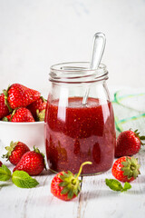 Strawberry jam in the glass jar.
