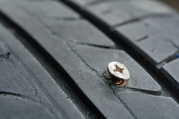 Close up metal screws nails embroidered in tires.