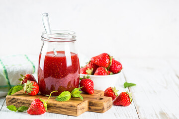 Strawberry jam in the glass jar.