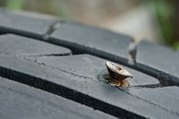 Close up metal screws nails embroidered in tires.