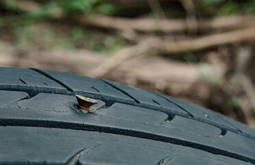Close up metal screws nails embroidered in tires.