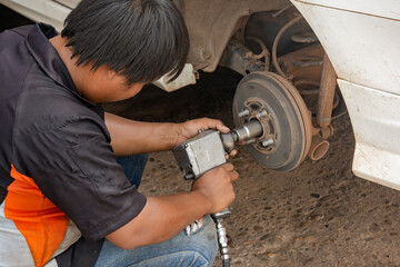 The mechanic repair drum brake of car