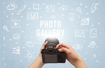 Hand taking picture with digital camera and PHOTO GALLERY inscription, camera settings concept