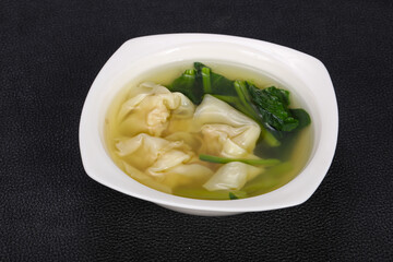 Asian traditional Wonton soup with herbs