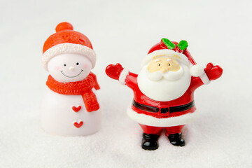 Merry Christmas and happy new year concept. Cute santa claus figure and tree on snow with copy space