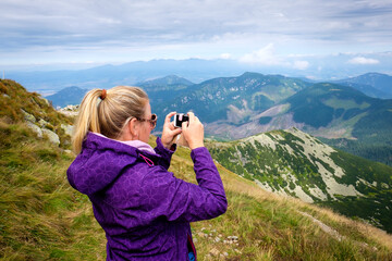 Woman wondering beautiful mountains from the top of Chopok, Slovakia