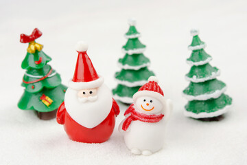 Fototapeta na wymiar Merry Christmas and happy new year concept. Cute santa claus figure and tree on snow with copy space