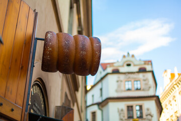 Trdelnik shop of traditional Czech pastries, advertising sign on the facade of the building