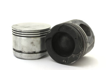 Old used engine pistons on white background