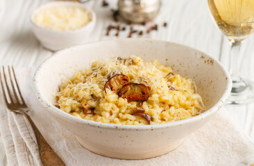 Risotto with porcini mushrooms, Parmesan cheese, Pecorino, onion, garlic, olive oil, dry white wine, freshly ground black pepper and aborio rice. Traditional dish of Mediterranean (Italian) cuisine