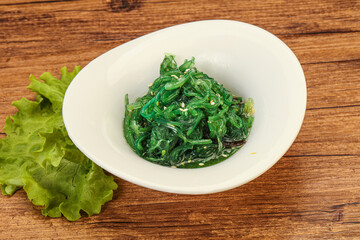 Green Chuka Seaweed Salad Isolated on White Background Top View. Wakame Sea Kelp Salat