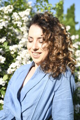 Fototapeta premium portrait of a woman with blooming flowers at summer