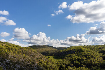 Park natural Garraf, green mountains with blue sky and clouds, Mas alba, Sitges, Spain