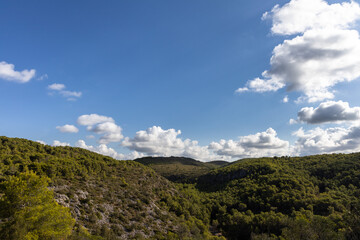 Naklejka na ściany i meble Park natural Garraf, green mountains with blue sky and clouds, Mas alba, Sitges, Spain