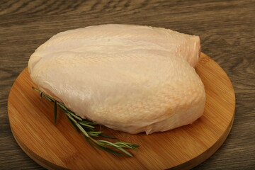 Raw whole chicken breast with skin