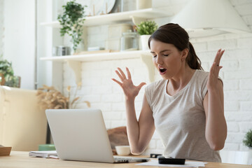 Stressful job and computer issues. Woman annoyed with slow Wi-Fi working on laptop. Angry user...