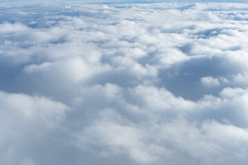 Fluffy clouds top view of the airplane. Heavenly landscape